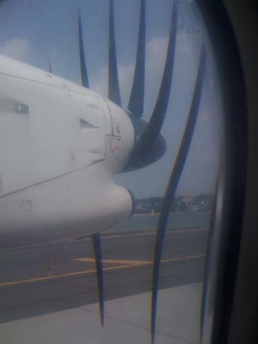 The front of a turboprop nacelle, showing the propellor, but the propellor is distorted into strange horizontal ribbons that don't seem to touch the shaft.