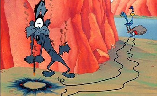 Picture of Wile E Coyote and the Roadrunner. The roadrunner is standing near a badly concealed bomb that the coyote tried to set off with a detonator. Except it was the detonator that exploded, leaving his fur charred and smoking.
